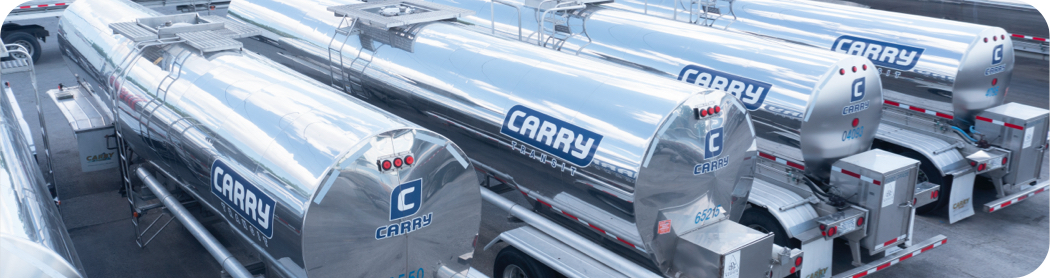 Four Carry Transit trucks parked next to each other